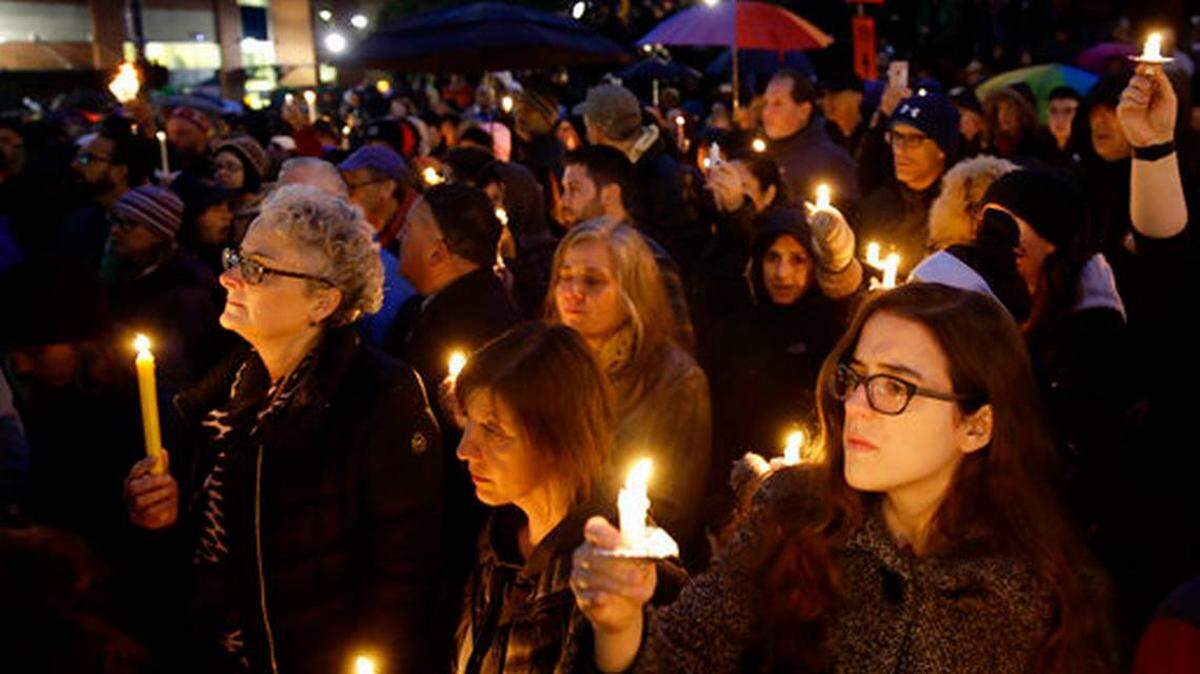 People hold candles as they gather for a vigil in the aftermath of Saturday’s deadly shooting at the Tree of Life Congregation, in the Squirrel Hill neighborhood of Pittsburgh.