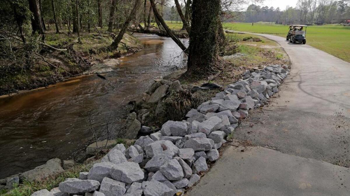 Lexington town officials put in rock on part of the Golden Hills golf course to stop erosion around the town sewer line next to 12 Mile Creek. The problem was created by increased flow in the creek due to the broken Old Mill Pond dam upstream.