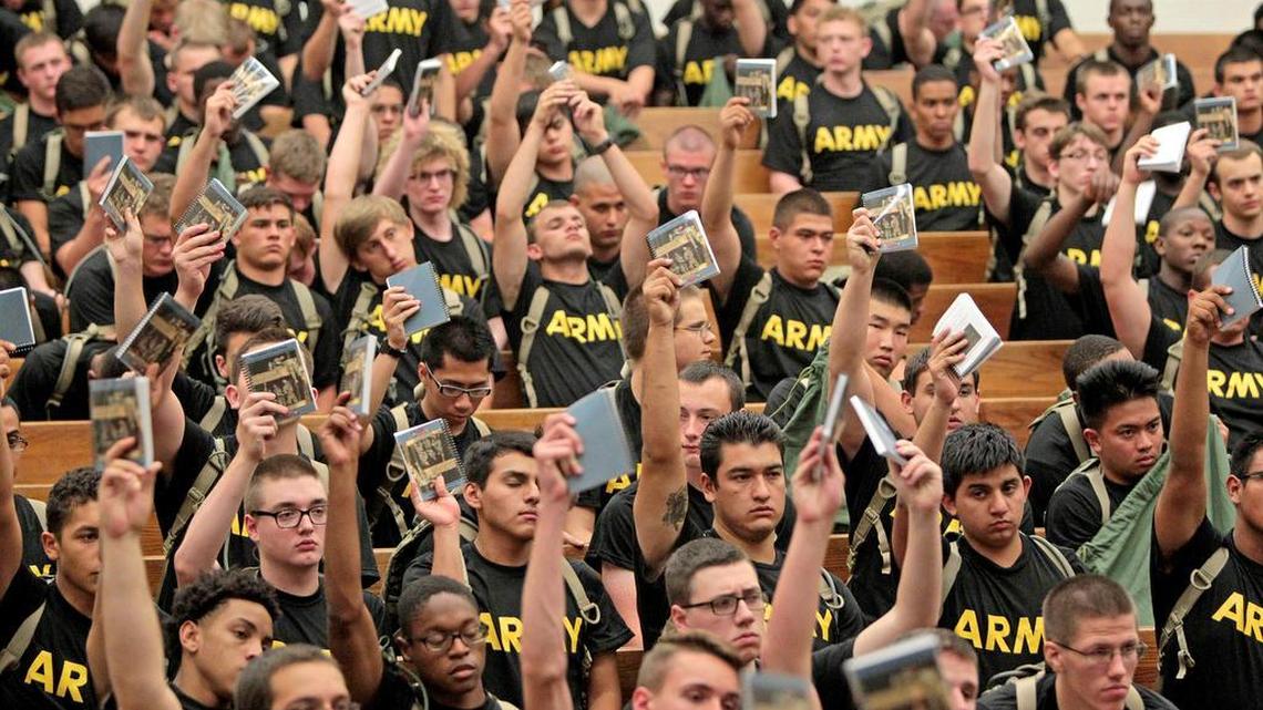 Recruits hold up "The Soldier's Blue Book" at the reception center in Fort Jackson. President Donald Trump’s budget includes $60 million for a new reception center at the fort.