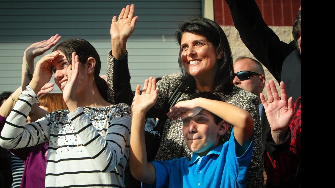 
Gov. Nikki Haley, their son Nalin, 10, and daughter Rena, 14, wave to First Gentleman Michael Haley, as the bus leaves for deployment to Afghanistan  in January 2013. 
