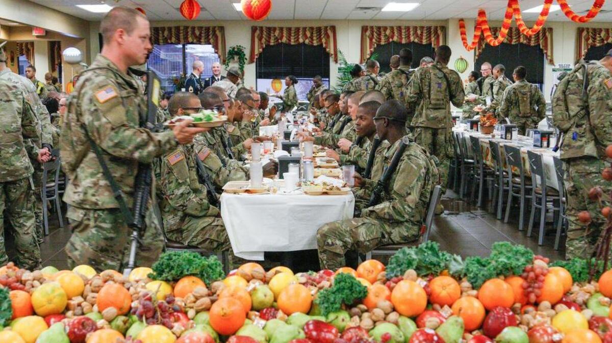 Recruits at Fort Jackson file in for their Thanksgiving meal during a Thanksgiving celebration at Fort Jackson. For many, the holiday is their first away from their families so the staff makes it special by serving the meal and including extras like dessert and shrimp.