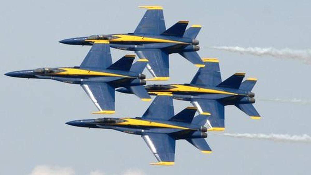 
Four planes of the U.S. Navy Blue Angels flight demonstration team pilot their F/A-18s in a tight diamond formation as they make a low pass during the 2011 MCAS Beaufort Air Show on Sunday. 
