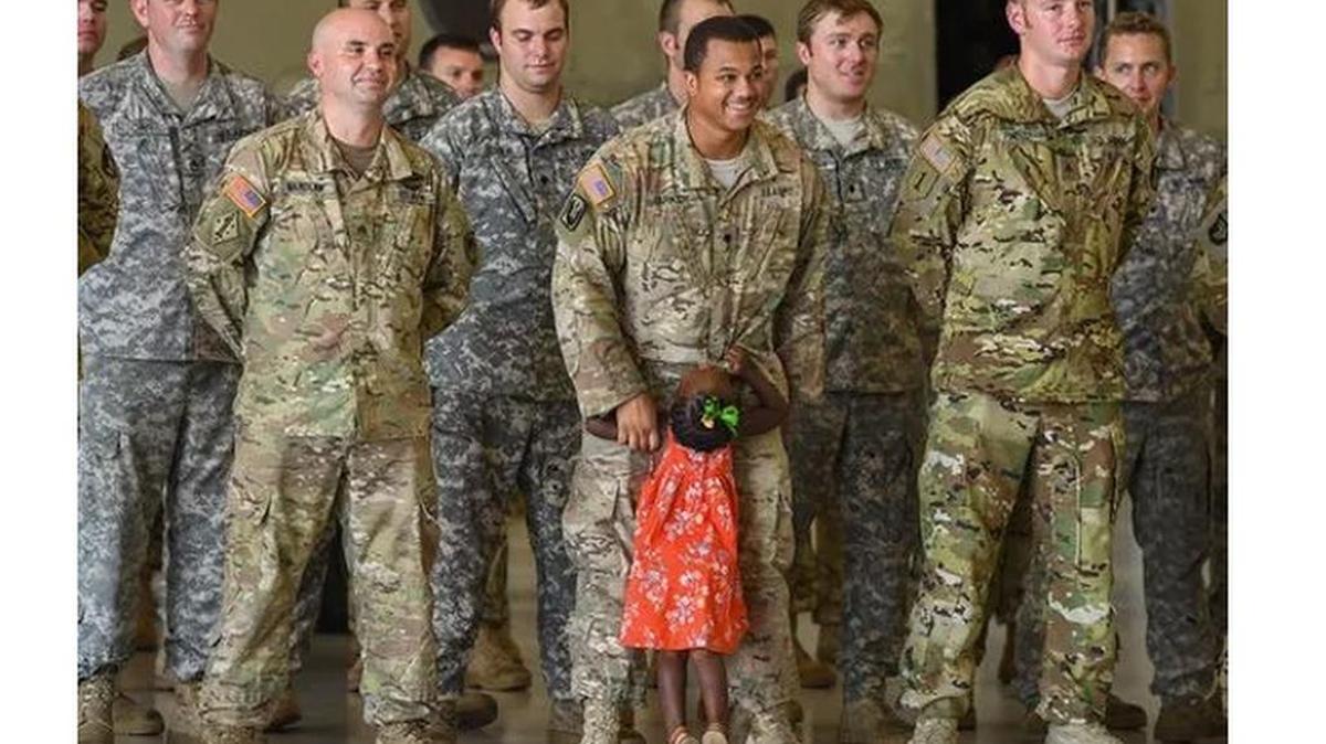 Specialist Kevin Parker breaks rank to pick up his two-year-old daughter Leah Mumford after she broke free from family members to get to him during the South Carolina Army National Guard's Det-1, Company B, 2-238th Aviation, General Support Aviation Battalion's departure ceremony at the Donaldson Center on Wednesday, August 23, 2017. Approximately 60 Soldiers will depart for their training station in Texas on Thursday for (Photo: BART BOATWRIGHT/Staff)