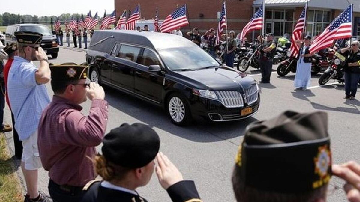 
A hearse carrying the remains of World War II fighter pilot Lt. Edward F. Barker leaves Albany International Airport on Wednesday. 
