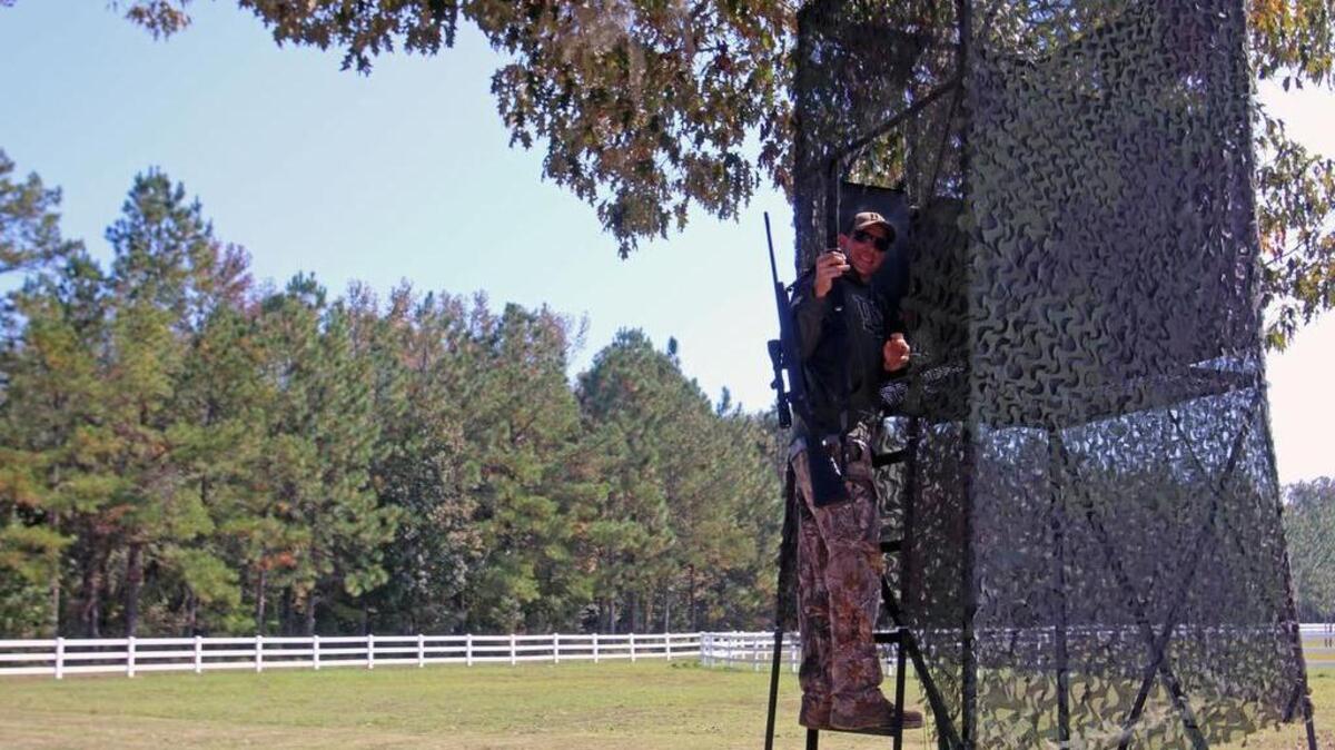 Army veterans John Wright steps up into a deer stand in River Neck Acres.