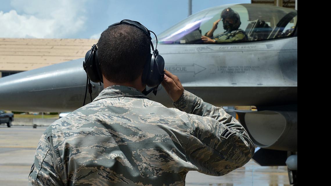 
A U.S. Air Force Airman assigned to the 20th Maintenance Group salutes an F-16CM Fighting Falcon during the operational readiness exercise Weasel Victory 15-06 at Shaw Air Force Base, S.C., May 27, 2015. 
