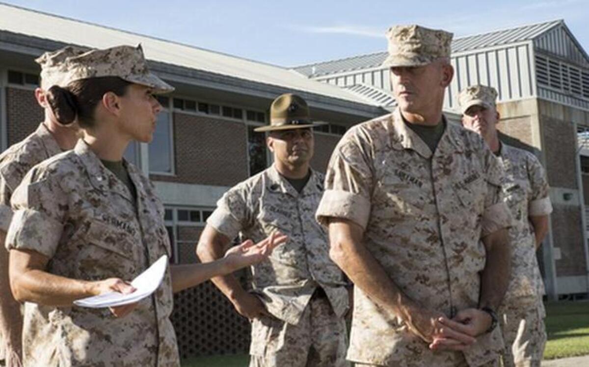 
Lt. Col. Kate Germano, left, the 4th Recruit Training Battalion commander, gives a tour of the 4th Battalion barracks complex to Maj. Gen. James Lukeman, a Beaufort native and commanding general of Marine Corps Training and Education Command, on Oct. 9, 2014, on Parris Island. "There aren't many jobs women Marines are hand picked specifically to do," Lukeman said. "You are the women Marine role models here." Germano was relieved of her command June 30, 2015, after an investigation into complaints that she created an abusive environment. 
