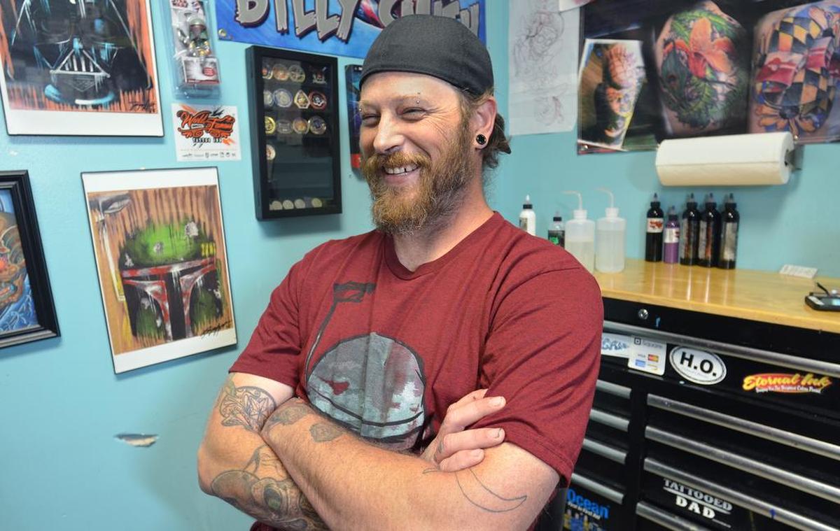 Beaufort tattoo artist Bill Smith, who often designs and creates tattoos for combat veterans memorializing their comrades who have died is photographed on Thursday at his tattoo studio Yes It Hurts! Tattoos.
