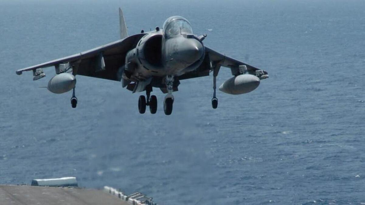 A Marine Corps AV-8B Harrier from the 1st Marine Air Wing hovers over the flight deck of the USS Boxer before landing on Aug. 2, 2005.