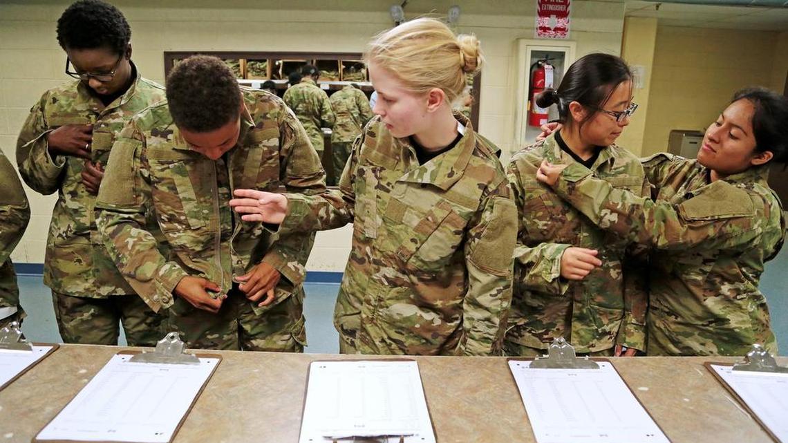 Jamie Udet, 18, middle, of Myrtle Beach, joins other recruits as they try on their uniforms for the first time, Thursday, June 30, 2016. Soldiers-in-training do all their in-processing in the reception stage, which includes paperwork, medical/dental screenings, shots and haircuts. They are also issued their uniforms and dogtags and begin their orientation in Army procedures & values.
