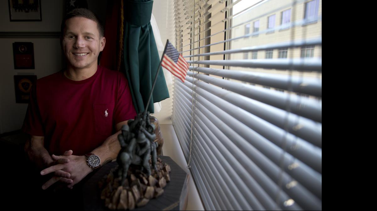 
This photo taken May 13, 2014 shows Medically retired Marine Lance Cpl. Kyle Carpenter speaking to media at the Pentagon. Carpenter is taking time at the end of his second year of college to escort a group of elderly military veterans to Washington. The now-retired Marine says he wants to show his appreciation for their service by accompanying them on Wednesday’s Honor Flight to view the nation’s military memorials. 
