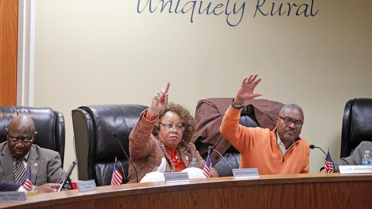 Richland County council members Joyce Dickerson, second from left, and Kelvin Washington vote at a 2015 council zoning hearing.