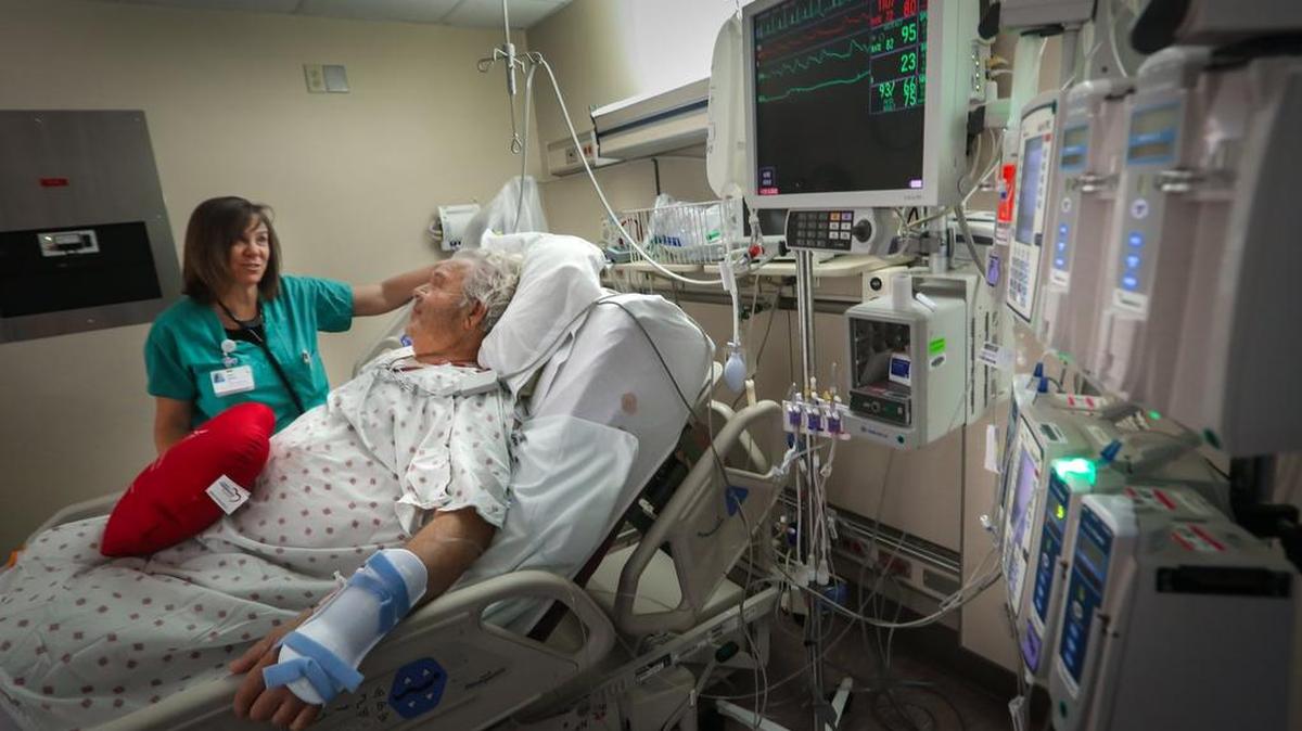 Traci Dennis, charge nurse in the Cardiovascular Surgery Recovery unit, talks with Bill Epting who had a heart procedure at Providence Hospital. The hospital is closing on it's sale to LifePoint Health.