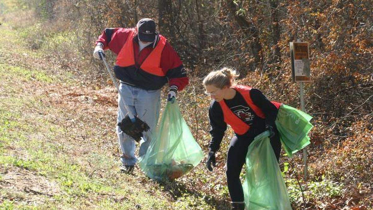 
Ed Siggelko and Katherine Kane pick up litter in the COWASEE Basin during the first annual COWASEE Clean-Up. 
