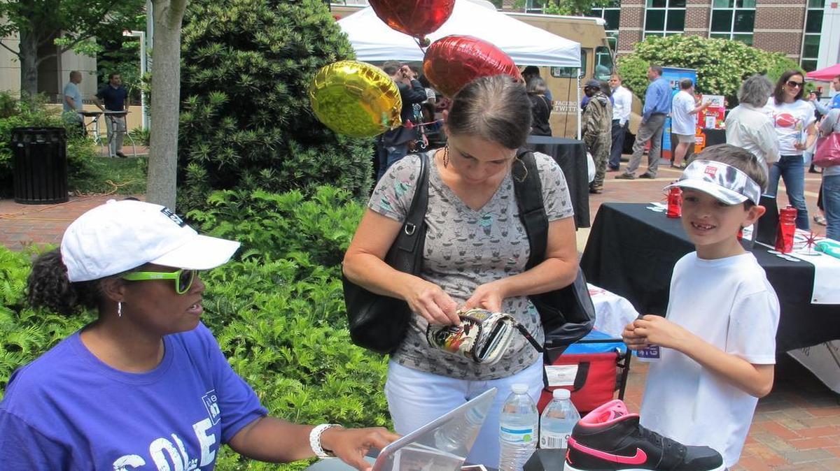 
Kate Ferlauto and her son, Lucas make a donation to Innersole Tuesday.
