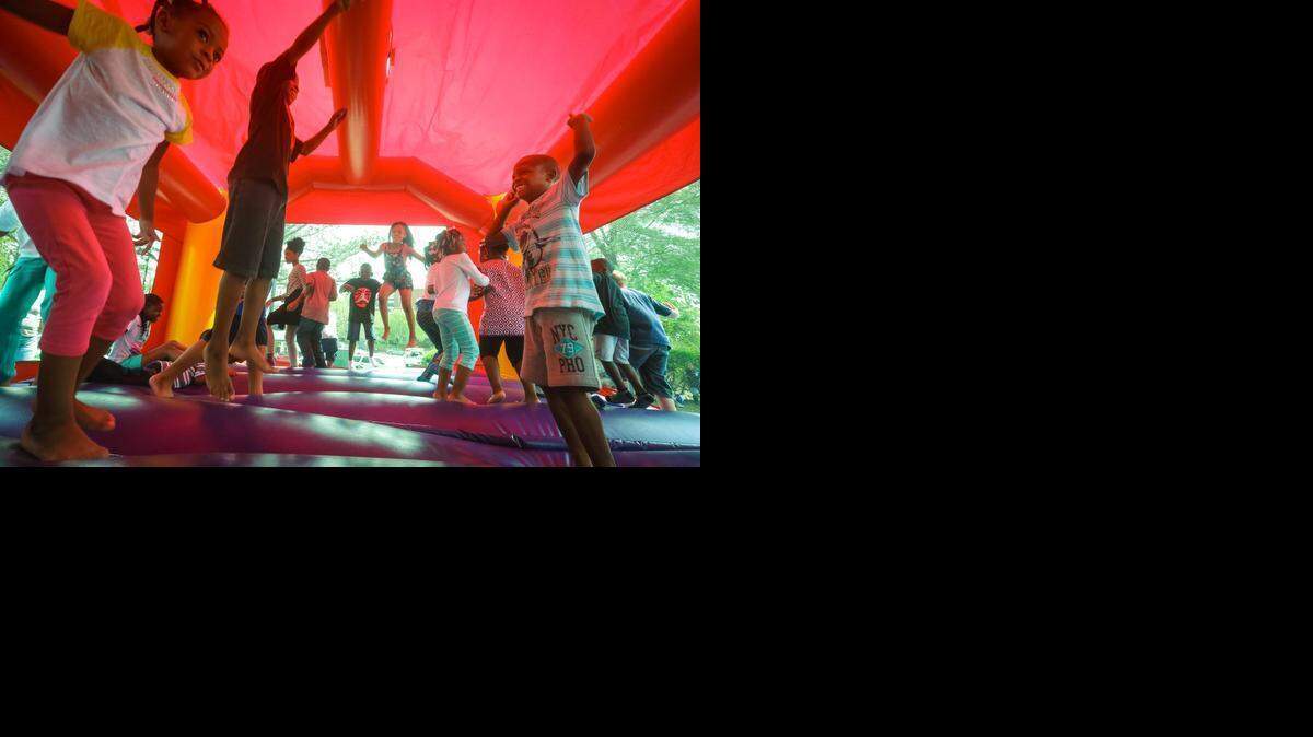 
Youngsters get moving in the bounch house during the city of Columbia’s Let's Move Easter egg hunt in Finlay Park Friday.
