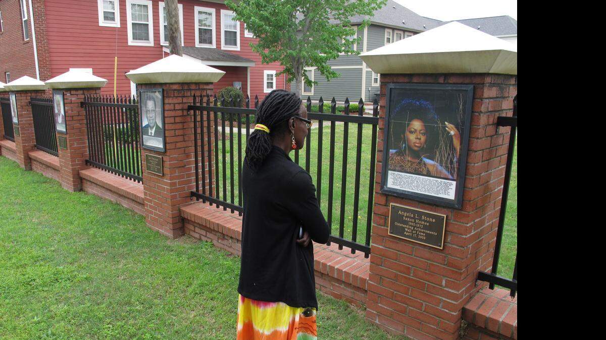 
Columbia resident Regina Brown visits the Wall of Fame on Read Street late last week.
