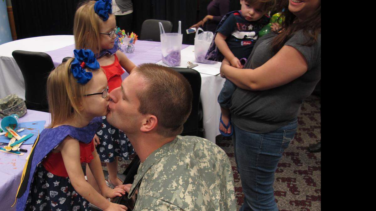 
Josh Bixler of Irmo is greeted with a kiss by his 3-year-old daughther, Addison, who took part in Wednesday’s celebration with her twin sister, Payton and 1-year-old brother Russo.
