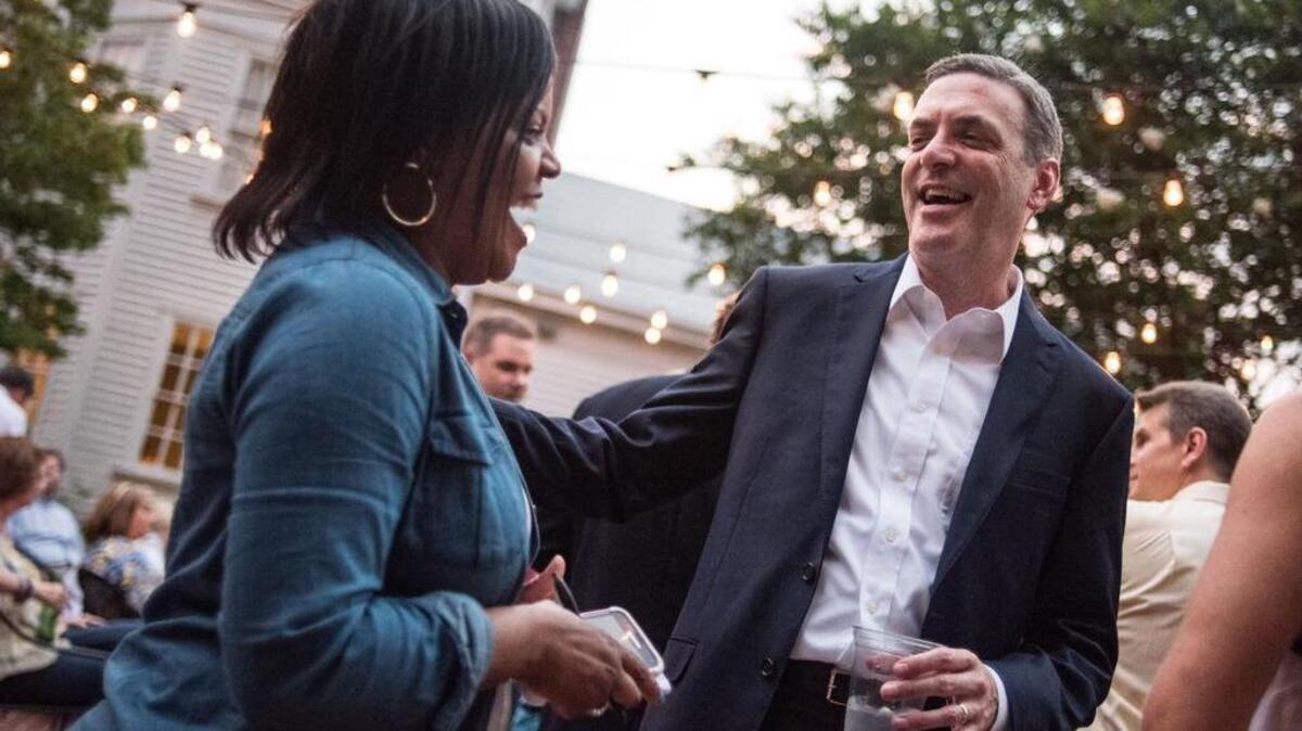 Lexington County solicitor candidate Rick Hubbard, right, gets a hug from Rhonda Patterson during a victory party Tuesday night at Private Property Restaurant in Lexington.