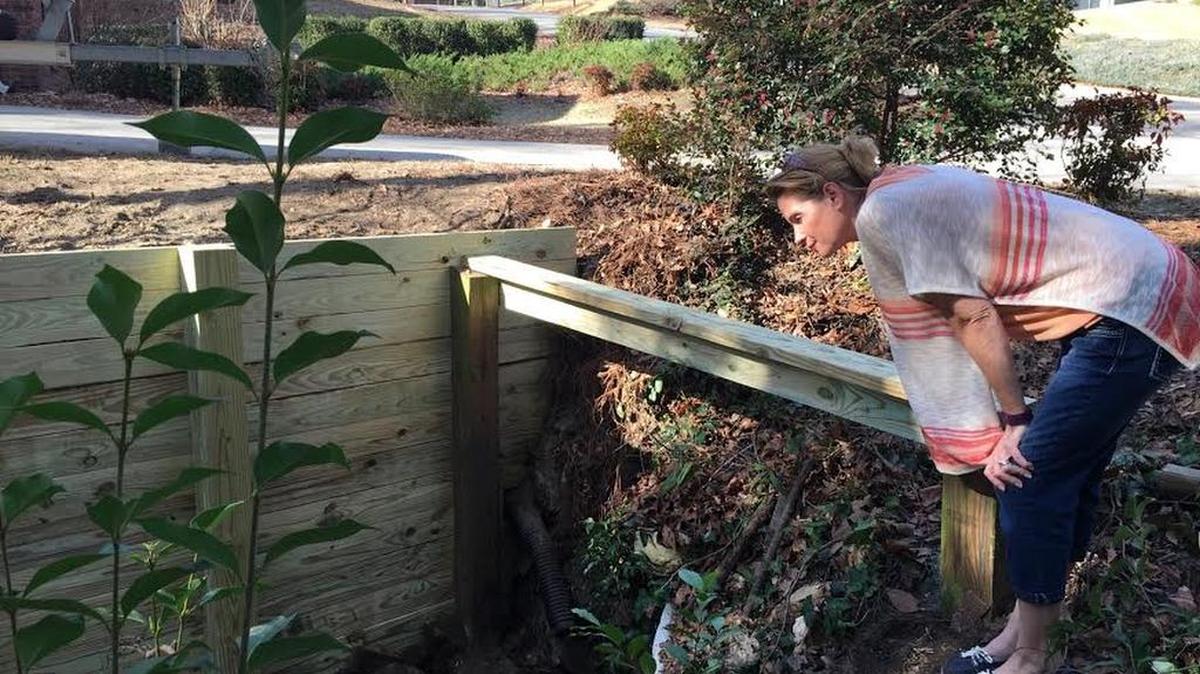 Joy Sullivan check on conditions in a stotmwater drainage ditch next to her home in the Westover Acres neighborhood in West Columbia.