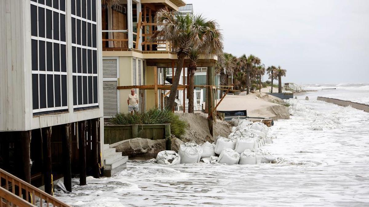 A man looks over the pounding surf caused by Hurricane Irma in the Wild Dunes Resort community of the Isle of Palms on Sunday.