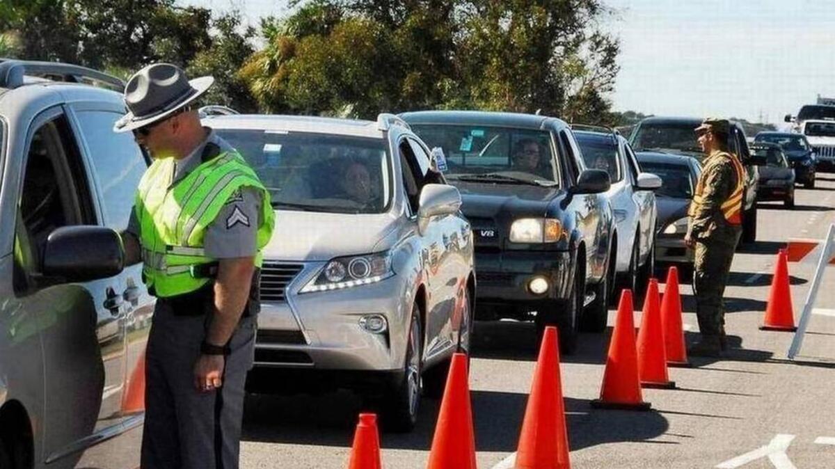 Cars line up at a checkpoint.