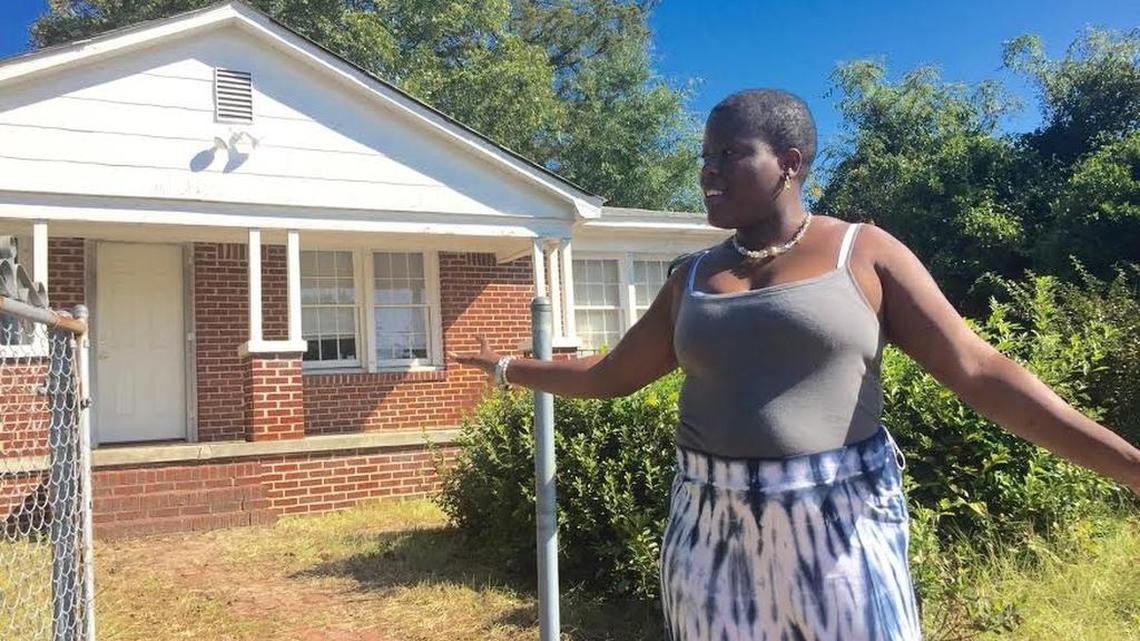 
Tanika Doctor stands in front of her family’s new house in the Rosewood area.

