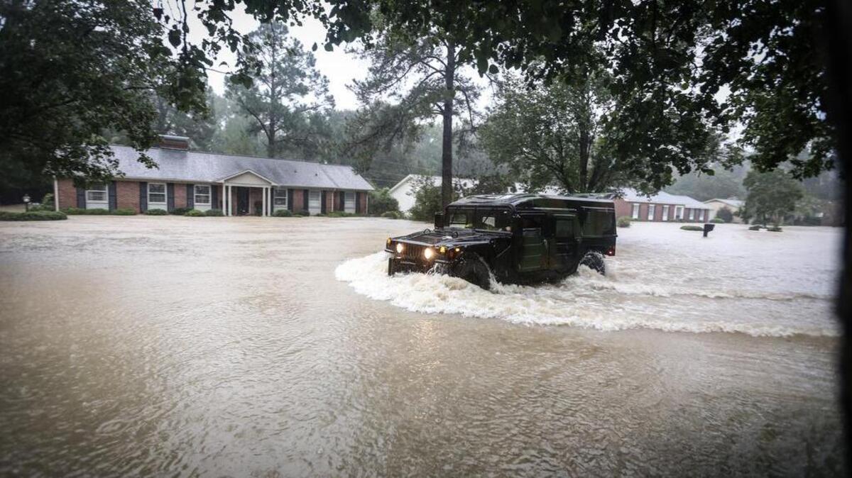 
A national guard hummer drives down Carter drive during a rescue in a forest acres neighborhood during Sunday morning’s flood on October 4, 2015. 

