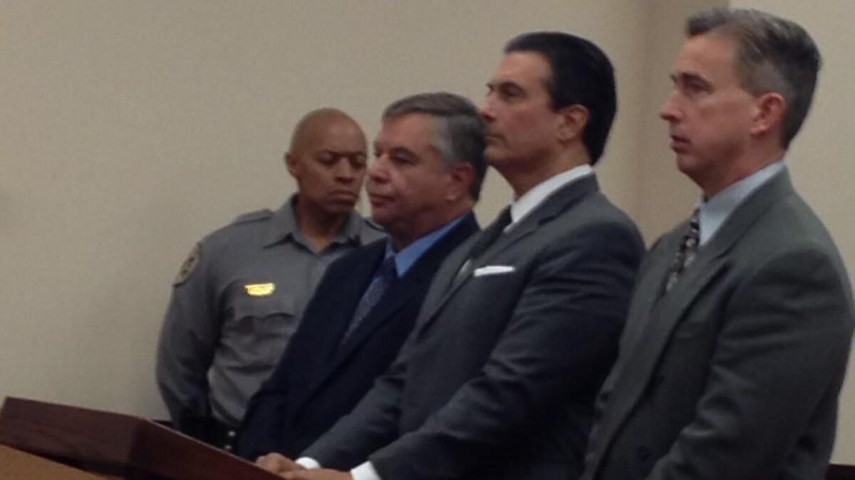 Bill Cabe, left, with his lawyers in court Friday.