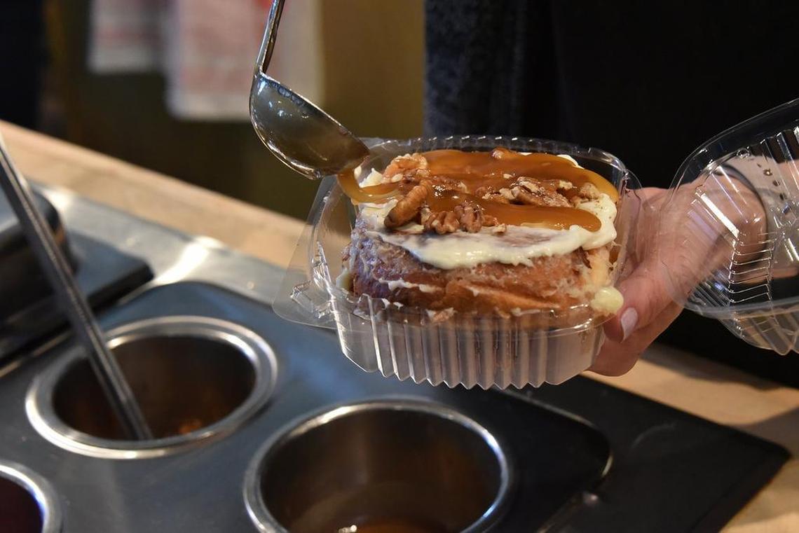 A special glaze is added to one of the specialty cinnamon rolls, the Bourbon Caramel Cinnamon Roll.