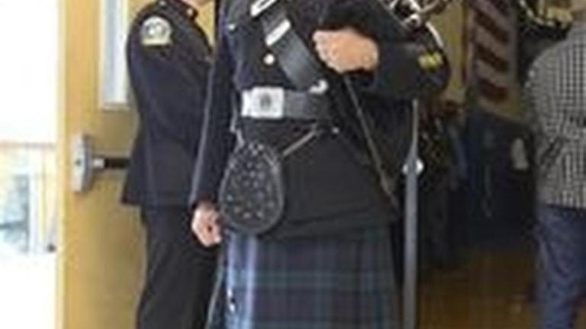 
A bagpiper plays ‘Going Home’ as fallen firefighter Jordan Howard’s coffin is taken from Marietta Baptist Church.
