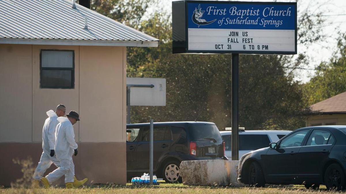 Members of the FBI walk next to the First Baptist Church of Sutherland Springs after a fatal shooting, Sunday, Nov. 5, 2017, in Sutherland Springs, Texas.