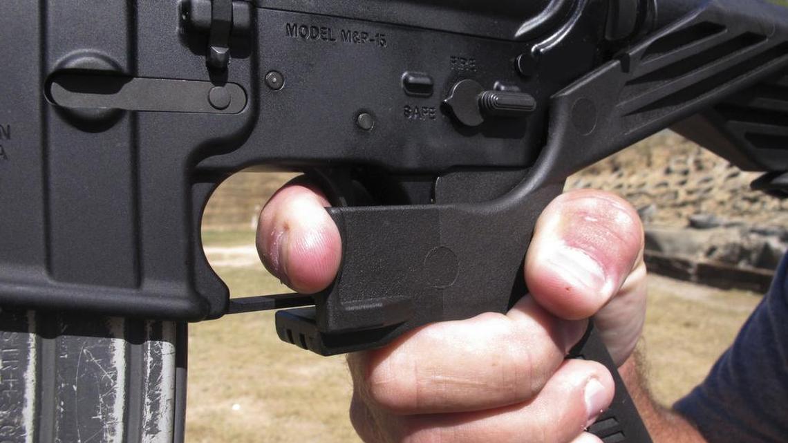 Shooting instructor Frankie McRae demonstrates the grip on an AR-15 rifle fitted with a bump stock at his 37 PSR Gun Club in Bunnlevel, N.C.