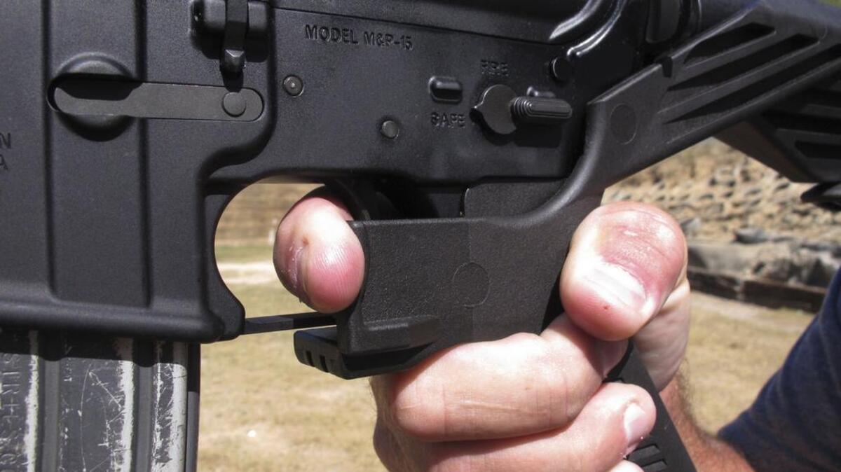 Shooting instructor Frankie McRae demonstrates the grip on an AR-15 rifle fitted with a bump stock at his 37 PSR Gun Club in Bunnlevel, N.C.