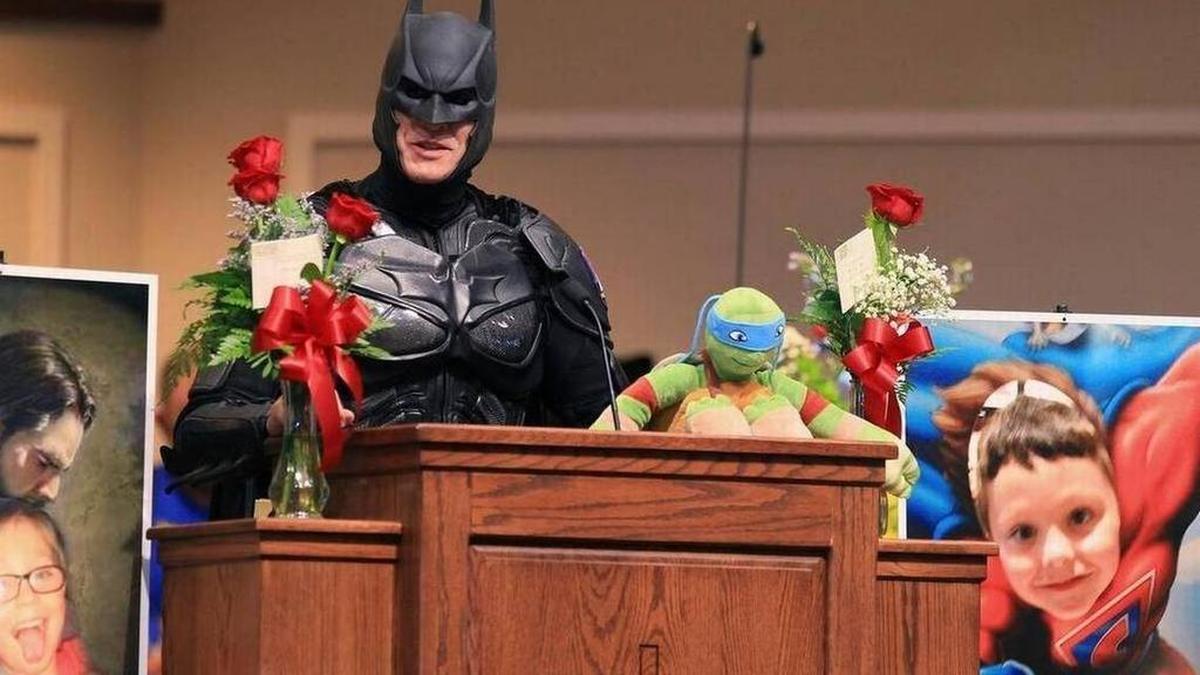 John Buckland, of Huntington W.V., dressed as Batman, speaks during a superhero-themed funeral service for Jacob Hall Wednesday at Oakdale Baptist Church in Townville.