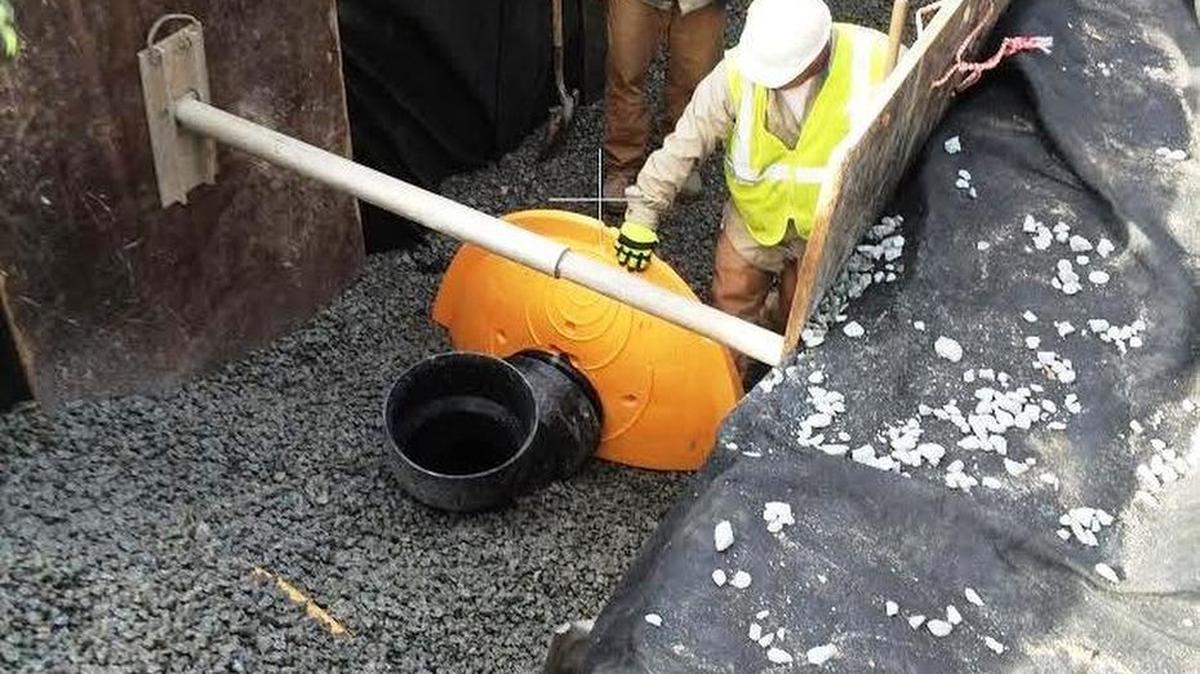 Workers install water retention chambers during an pilot flood-control program in Shandon that proved more expensive than city officials expected.