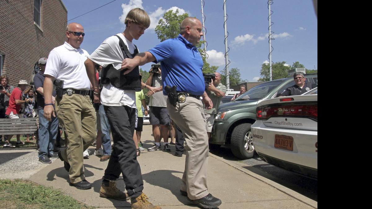 
Charleston, S.C., shooting suspect Dylann Storm Roof is escorted from the Sheby Police Department in Shelby, N.C., Thursday, June 18, 2015.
