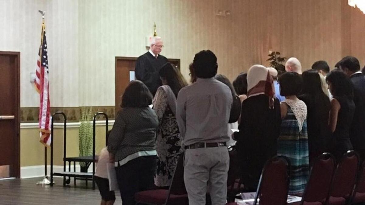 Federal Judge Joe Anderson delivered the naturalization oath to 41 new Americans during a lunch meeting of the Columbia Rotary Club.