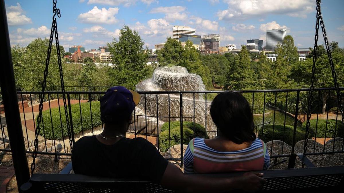 Royce Ennett and Quante Ervin enjoy the Columbia skyline accented by the fountain at Finlay Park in June 2014, when the fountain was running.