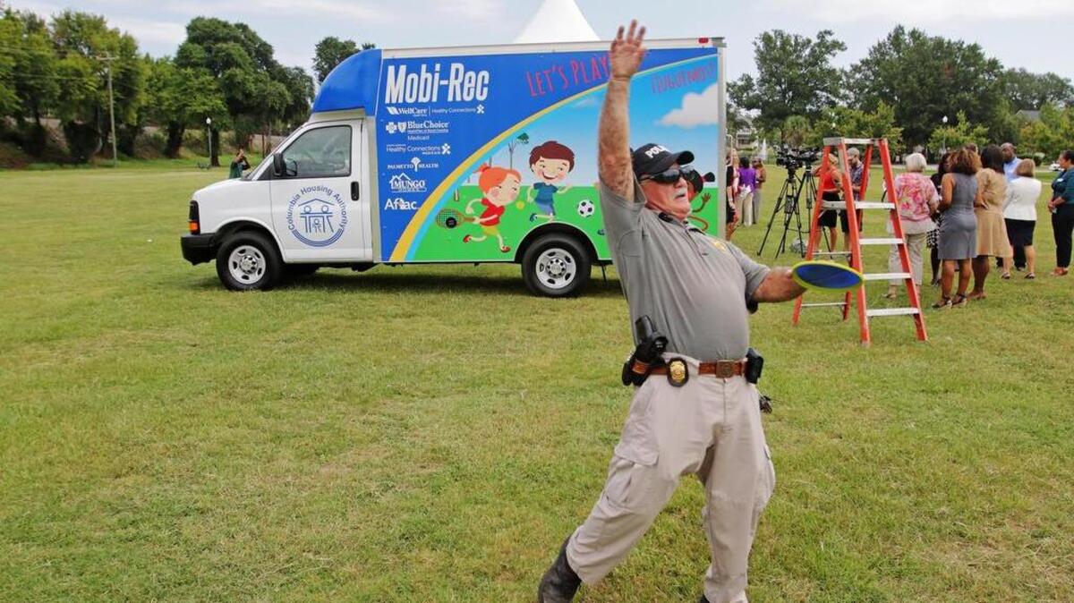 
Angel Cruz, chief of security for Columbia Housing Authority, takes the opportunity to try out some of the recreation equipment inside the Mobi-Rec on Wednesday. The van outfitted with a variety of recreation equipment will travel to select neighborhoods within Columbia. It is designed to increase opportunities for youth to participate in safe, structured play and recreation in areas where access is limited.
