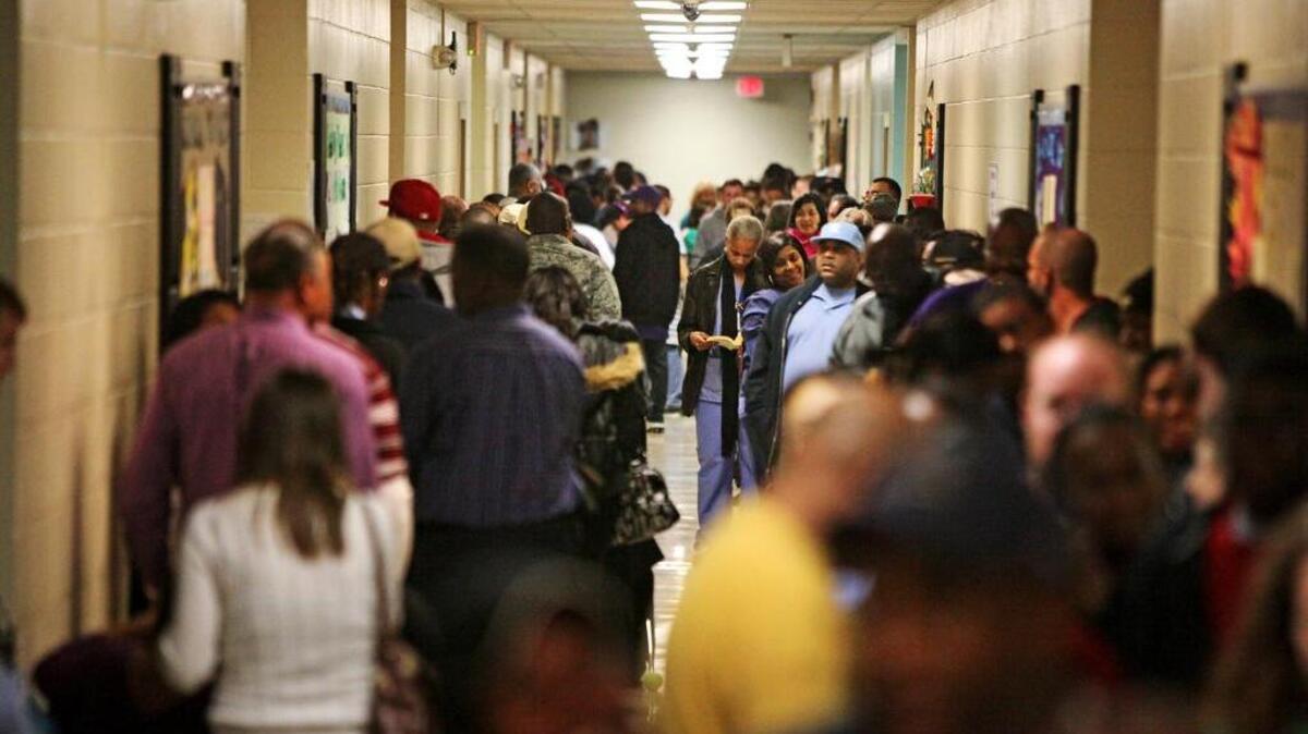 A crowd of voters at Rice Creek Elementary on Hard Scrabble Road waited up to four hours in November 2012 to cast their ballots. Lines like these were duplicated in dozens of precincts, some outdoors on that wet and cold day.