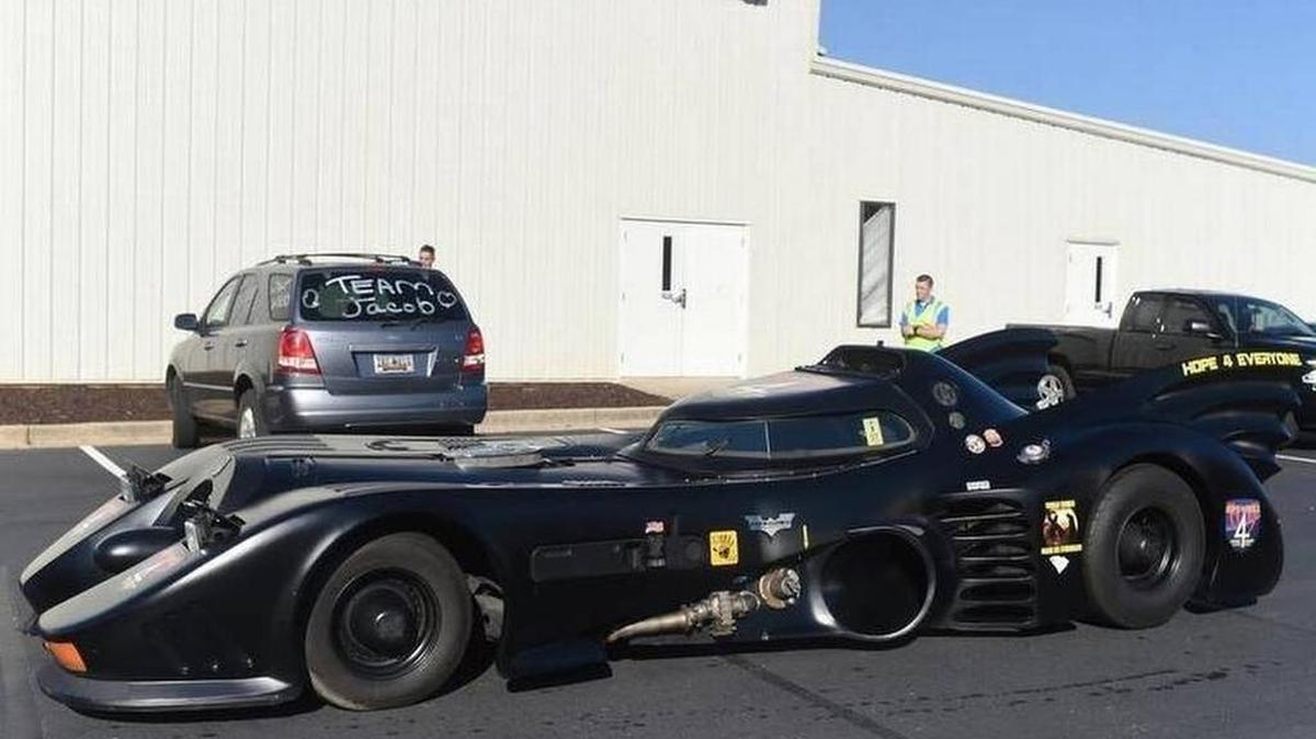 A Batmobile arrives before a superhero-themed funeral service for Jacob Hall, a 6-year-old boy who was killed in a school shooting.