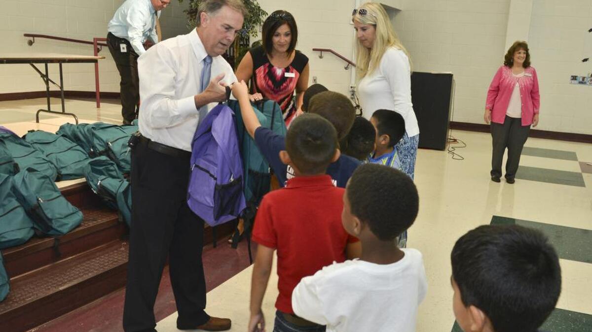 
Lexington Golden State Food Foundation member Darwin McDonald hands a new backpack full of school supplies to first-graders at Davis Early Childhood Center for Technology in Cayce on Wednesday.
