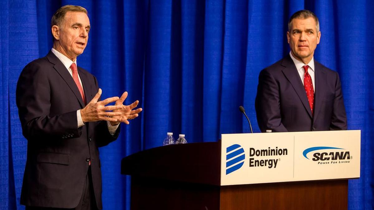 Thomas Farrell II, left, chairman, president and CEO of Dominion Energy, and Jimmy Addison, CEO of SCANA, speak during a news conference at SCANA headquarters in Cayce.