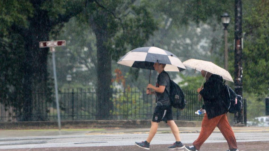 University of South Carolina students walk through campus during heavy rains brought through South Carolina by tropical storm Hermine on Sept. 2, 2016.