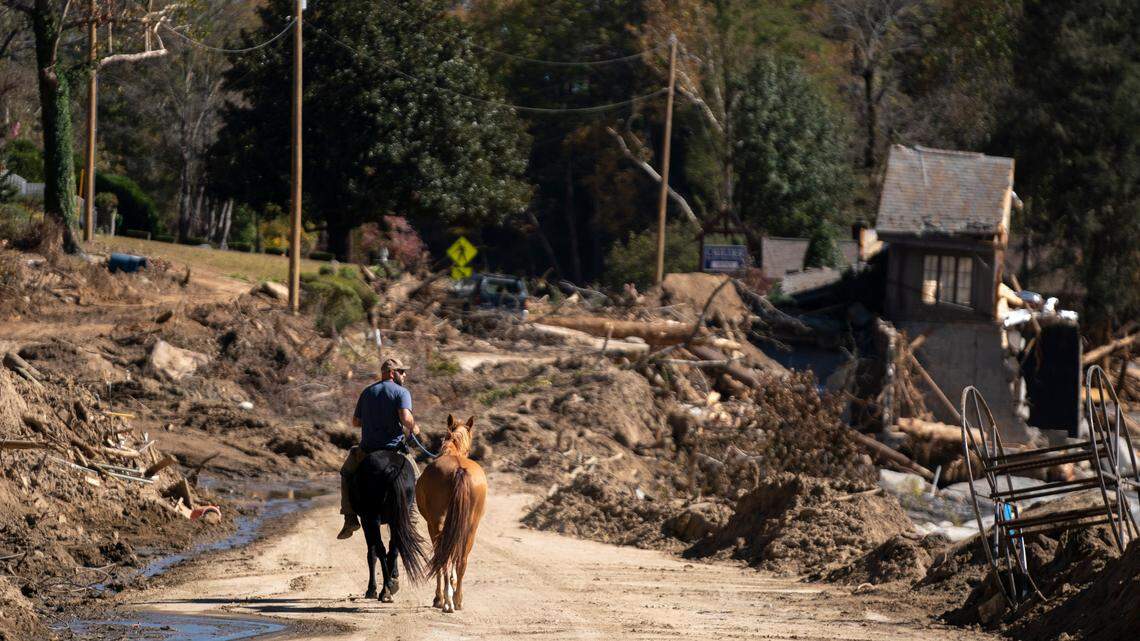 A man rides a horse in Bat Cave on Oct. 21, 2024. The town in the Western North Carolina mountains was hit hard by Hurricane Helene.