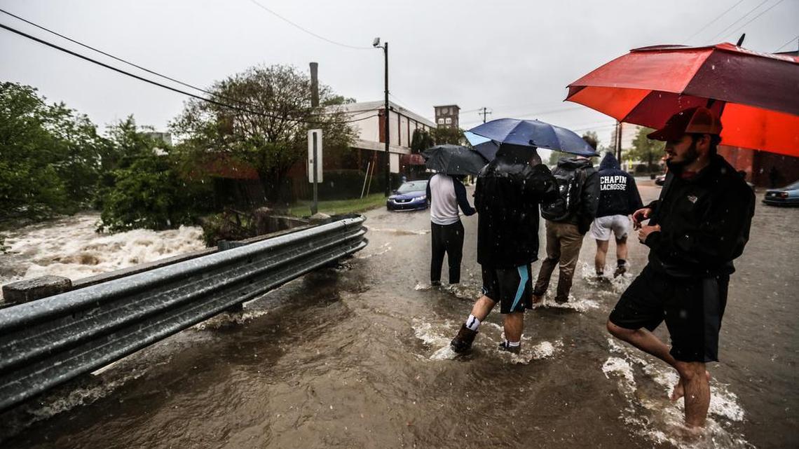 USC students make their way along Catawba, near Assembly Street on Wednesday. Many downtown Columbia streets flooded as a series of storms washed across the Southeast.