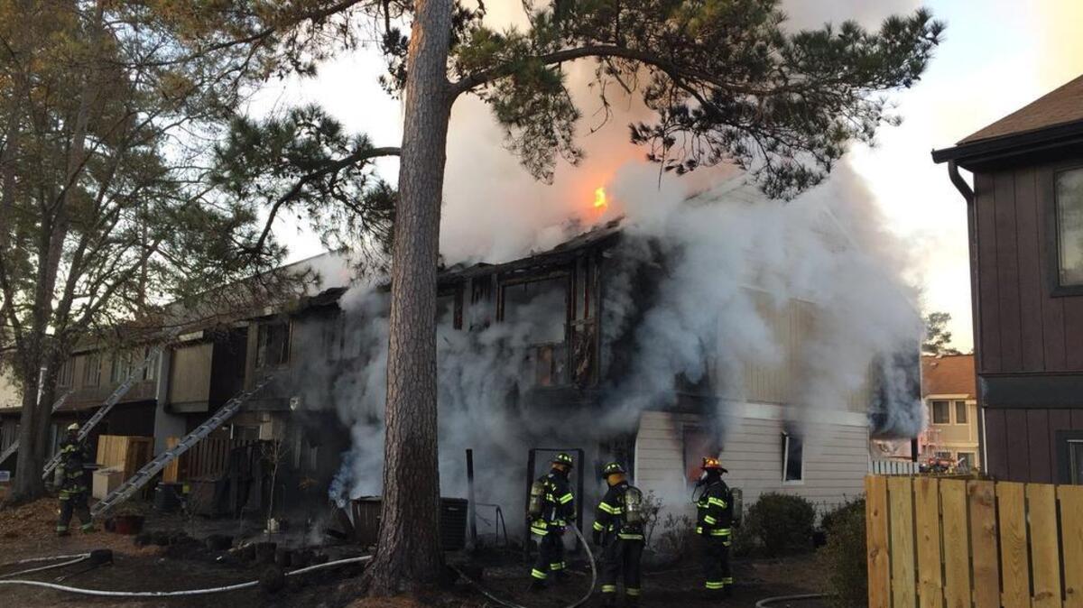 Fire officials say a 70-year-old man died after running back into a burning Forest Acres condo to save his sleeping wife.