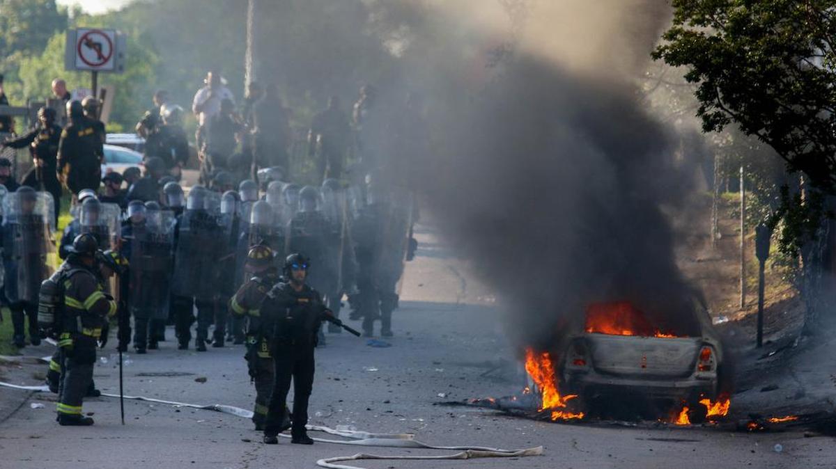 A police car burns after A Black Lives Matter rally escalated to groups attacking law officers, breaking into businesses and burning police cars in the Columbia Vista on May 30 2020.