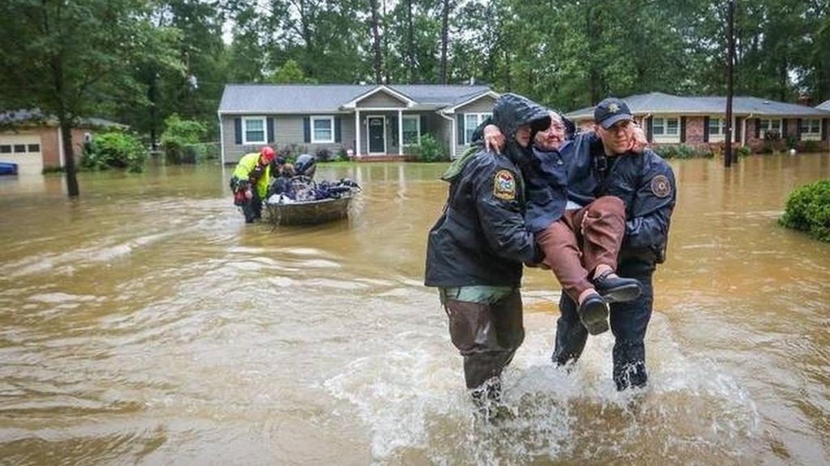 State natural resources officer Brett Irvin (left) and Lexington County deputy Dan Rusinyak carried June Loch to safety after the Pine Glen neighborhood flooded in October 2015.